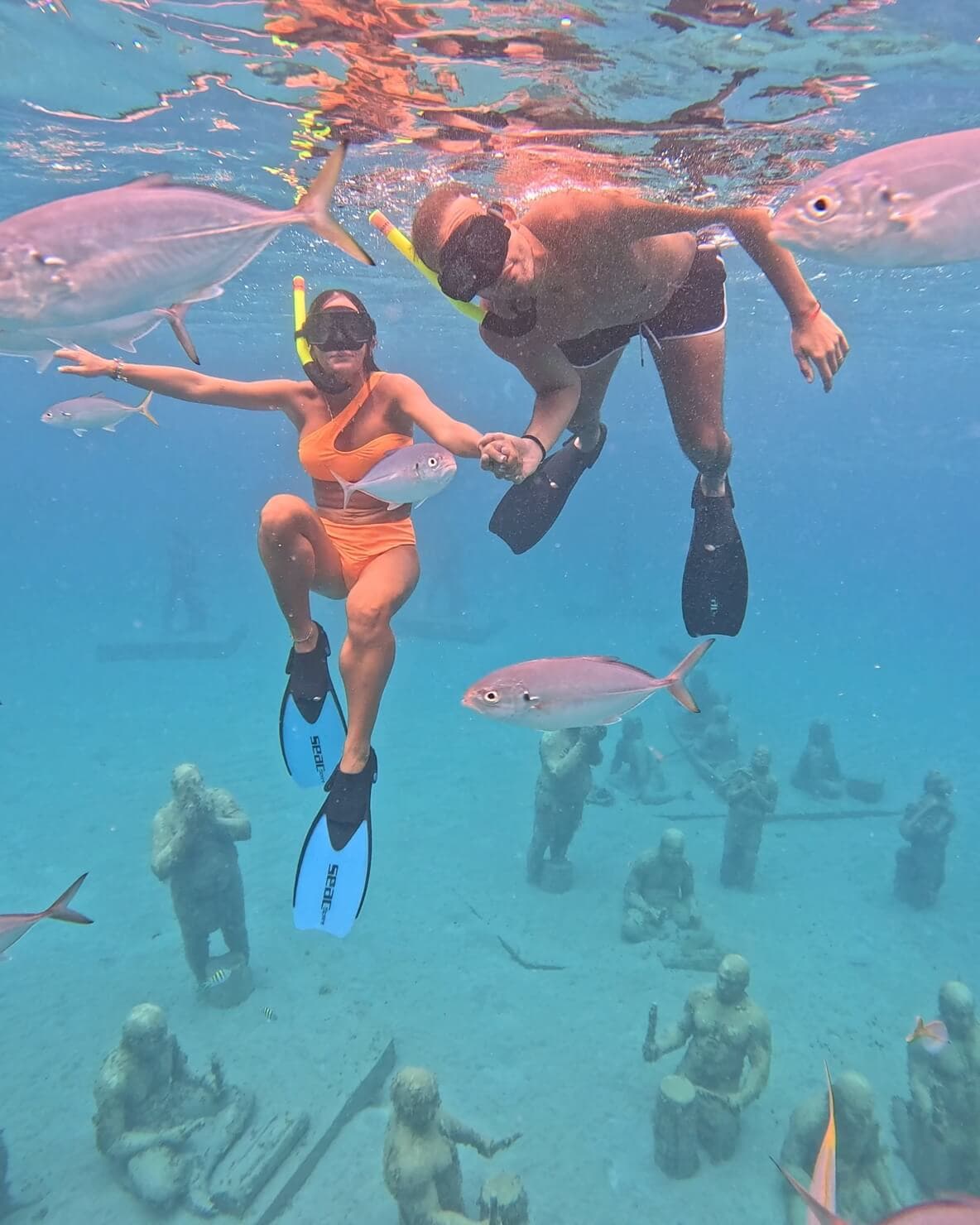 Couple snorkeling amongst the marine life at the Under SXM underwater sculpture park